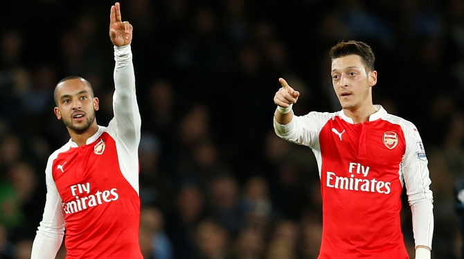 Theo Walcott celebrates with Arsenal teammate Mesut Ozil 
