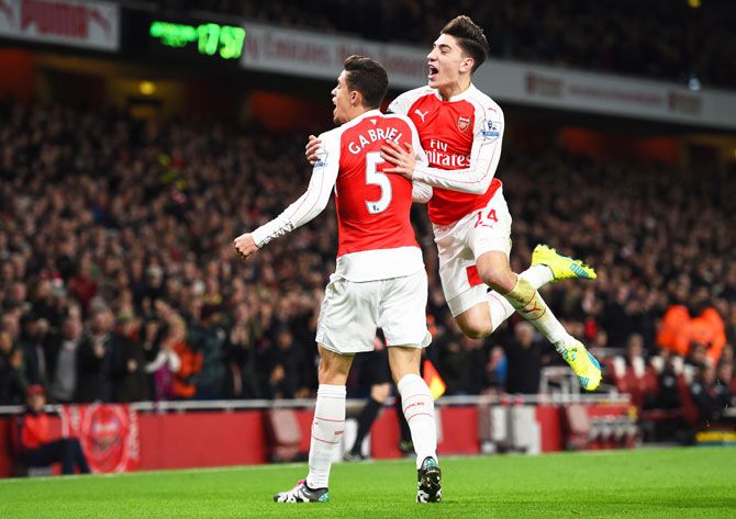 Arsenal's Gabriel (left) celebrates with his teammate Hector Bellerin (right) after scoring his team's first goal against Bournemouth at Emirates Stadium on Monday