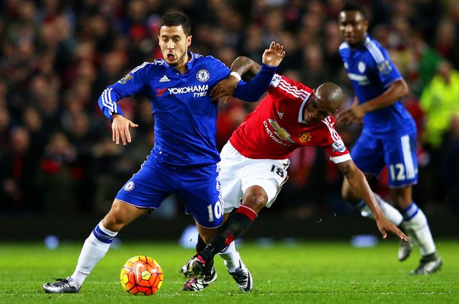 Chelsea's Eden Hazard battles for the ball with Manchester United's Ashley Young during their Barclays English Premier League match at Old Trafford in Manchester on Monday