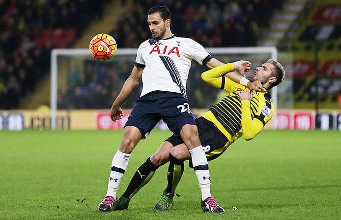 Watford's Valon Behrami is challenged by Tottenham's Nacer Chadli during their EPL match at Vicarage Road in Watford on Monday