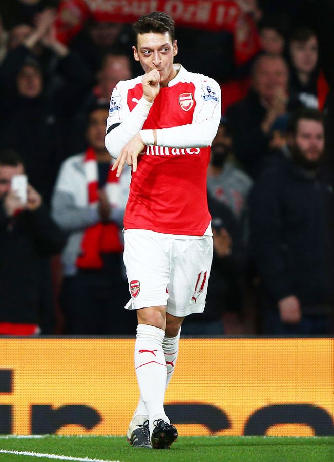 Arsenal's Mesut Ozil celebrates scoring his team's second goal against Bournemouth during their Barclays English Premier League match at Emirates Stadium in London on Monday