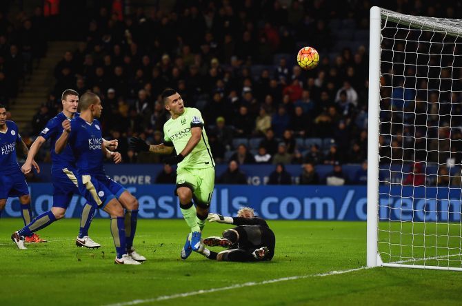 Sergio Aguero of Manchester City misses as Leicester City goalkeeper Kasper Schmeichel attempts to block