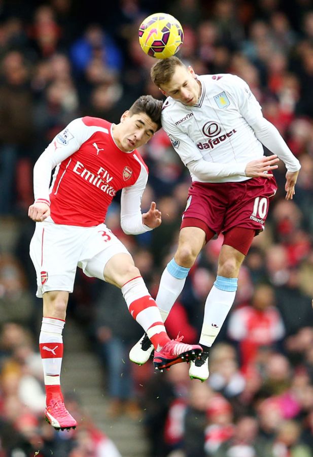 Andreas Weimann of Aston Villa and Hector Bellerin of Arsenal get involved in an aeriel challenge 