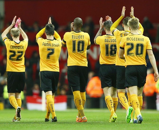 Cambridge United players applaud the travelling fans during the FA Cup Fourth round match