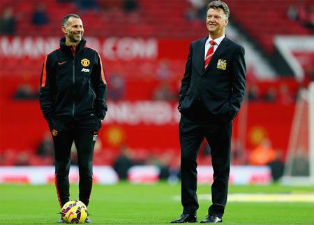 Assistant Ryan Giggs of Manchester United and manager Louis van Gaal walk on the pitch prior to a Premier League match