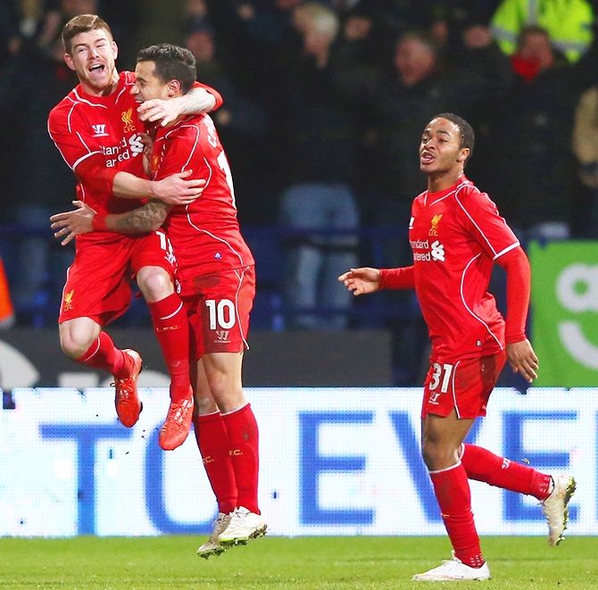 Philippe Coutinho of Liverpool celebrates scoring their second goal with Alberto Moreno and Raheem   Sterling
