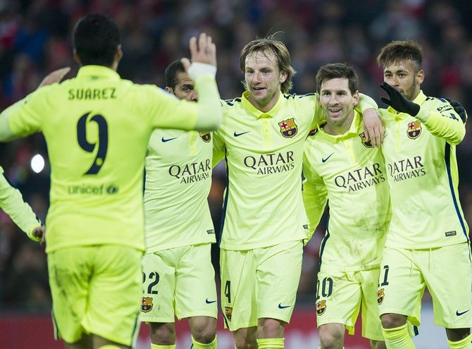 Lionel Messi, second right, of FC Barcelona celebrates after scoring