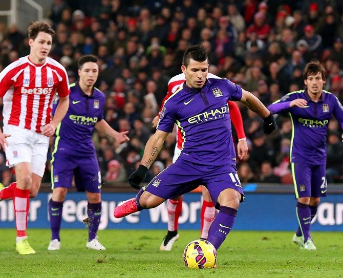Sergio Aguero of Manchester City scores his team's third goal from the penalty spot