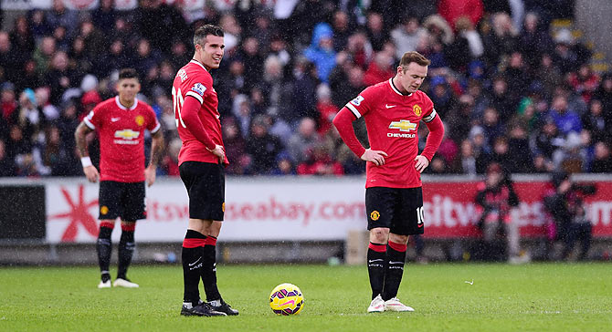  Robin Van Persie (l) and Wayne Rooney of Manchester United react after the second Swansea goal during the Barclays Premier League match between Swansea City and Manchester United at Liberty Stadium on Saturday