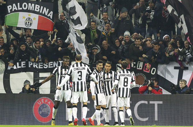 Alvaro Morata (3nd from right) of Juventus FC celebrates with team-mates after scoring against Borussia Dortmund during the UEFA Champions League Round of 16 match at Juventus Arena in Turin on Tuesday