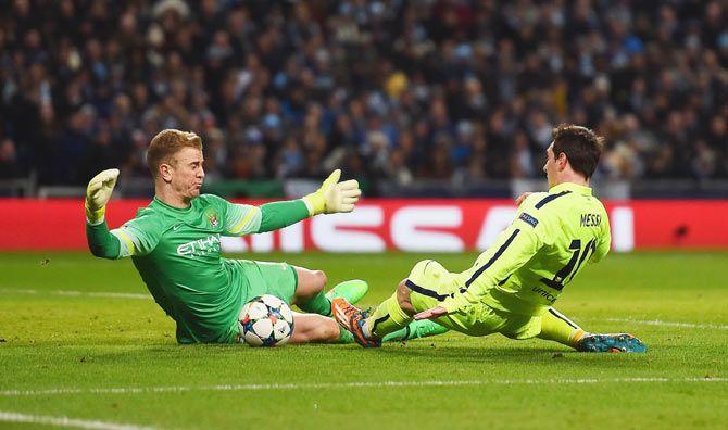 Joe Hart of Manchester City makes a save from Lionel Messi of Barcelona during their UEFA Champions League Round of 16 match