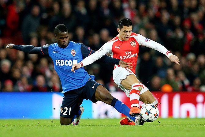 Alexis Sanchez of Arsenal is tackled by Elderson Uwa Echiejile of Monaco during the UEFA Champions League round of 16, first leg match