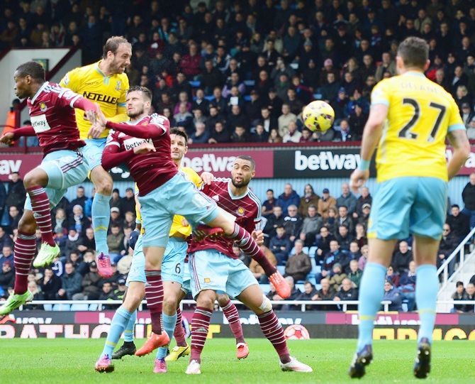 Glenn Murray of Crystal Palace, second left, scores their first goal with a header
