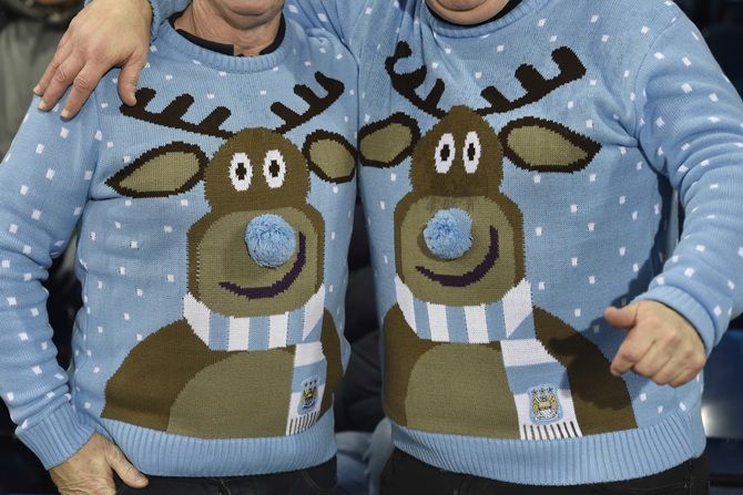 Fans wear Christmas jumpers during the English Premier League soccer match