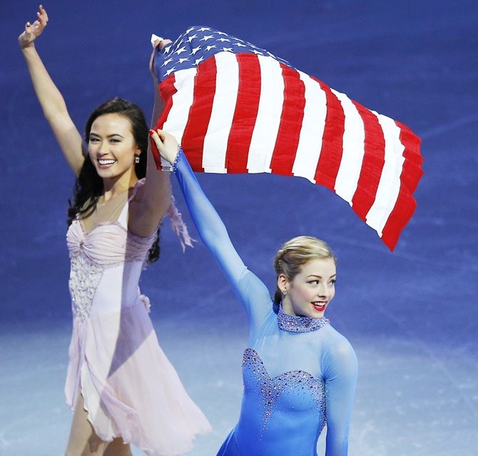  Team USA's Olympic figure skating team members Madison Chock and Gracie   Gold wave to the crowd in Boston