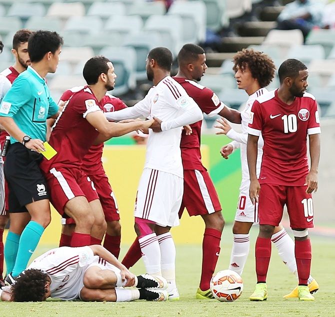 Players react after a foul on Mohamed of the United Arab Emirates