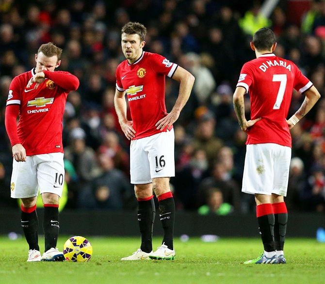 Wayne Rooney, Michael Carrick and Angel di Maria of Manchester United show their dejection