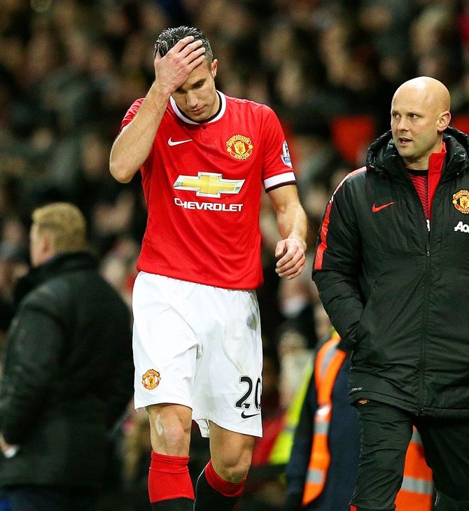 Robin van Persie of Manchester United reacts as he leaves the pitch