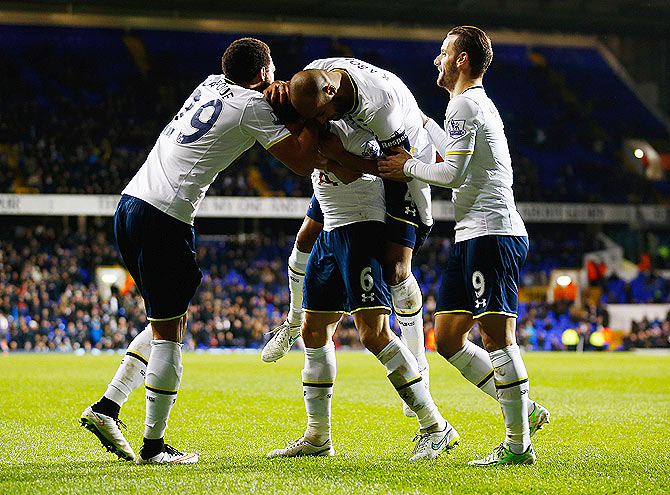 Vlad Chiriches of Spurs (6) celebrates with teammates after scoring their third goal during the FA Cup third round Replay match against Burnley at White Hart Lane in London on Wednesday