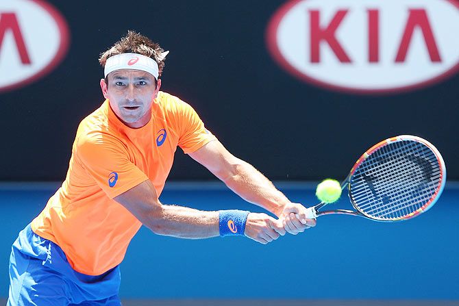 Marinko Matosevic of Australia plays a backhand in his second round match against Andy Murray of Great Britain on Wednesday