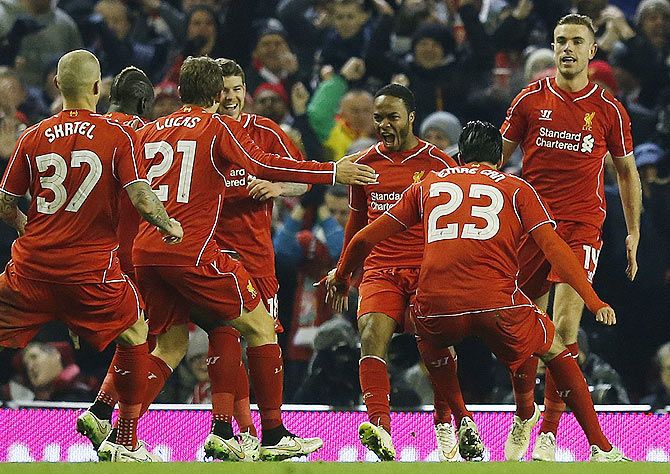 Liverpool's Raheem Sterling (3rd from right) celebrates with teammates after scoring against Chelsea during their English League Cup semi-final first leg match at Anfield on Tuesday
