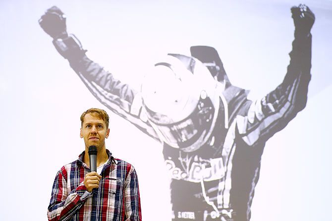 Sebastian Vettel of Germany speaks on stage during a visit to the Red Bull Racing Factory
