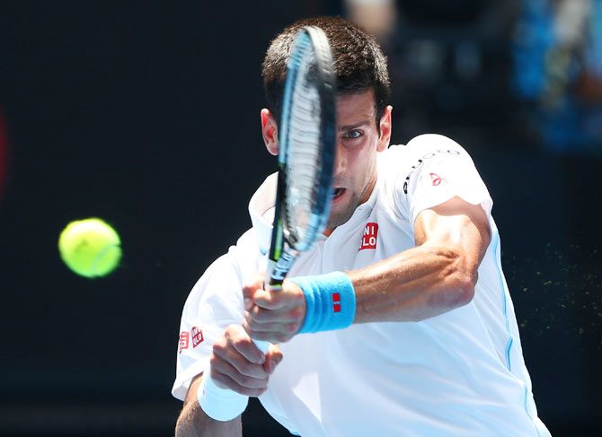 Novak Djokovic of Serbia plays a backhand in his second round match against Andrey Kuznetsov of Russia during the 2015 Australian Open at Melbourne Park on Thursday
