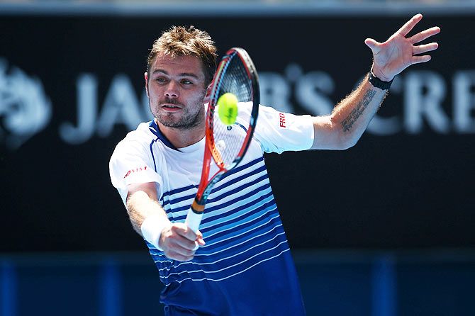 Stanislas Wawrinka of Switzerland plays a backhand in his second round match against Marius Copil of Romania
