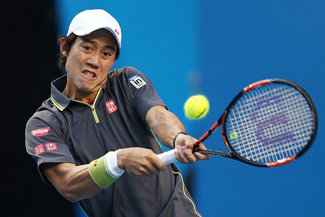 Kei Nishikori of Japan plays a backhand in his third round match against Steve Johnson of the United States