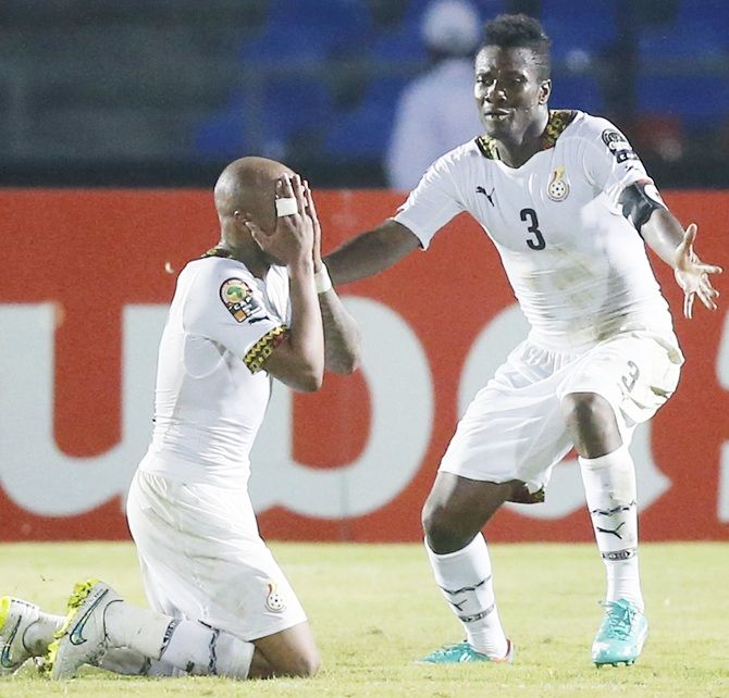 Ghana's Andre Ayew, left, celebrates his goal against South Africa with teammate Asamoah Gyan