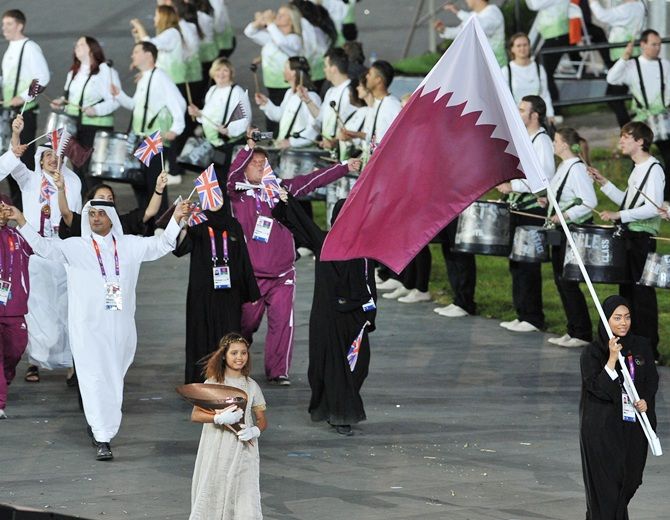 Bahya Mansour Al Hamad of the Qatar Olympic shooting team carries her country's flag during the Opening   Ceremony of the London 2012 Olympic Games