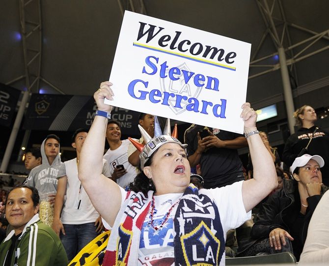 A fan holds a welcome sign as the new Los Angeles Galaxy midfielder Steven Gerrard