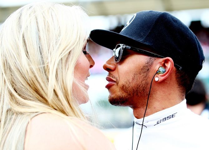 Lewis Hamilton of Great Britain and Mercedes GP speaks with Lindsey Vonn 
