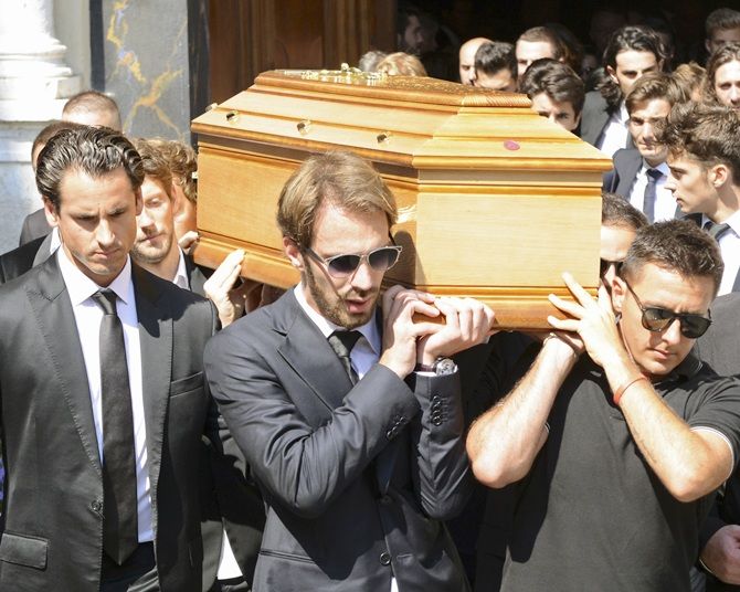 Formula One driver Jean Eric Vergne, centre, with drivers and friends carry the coffin of late Marussia F1 driver Jules Bianchi 