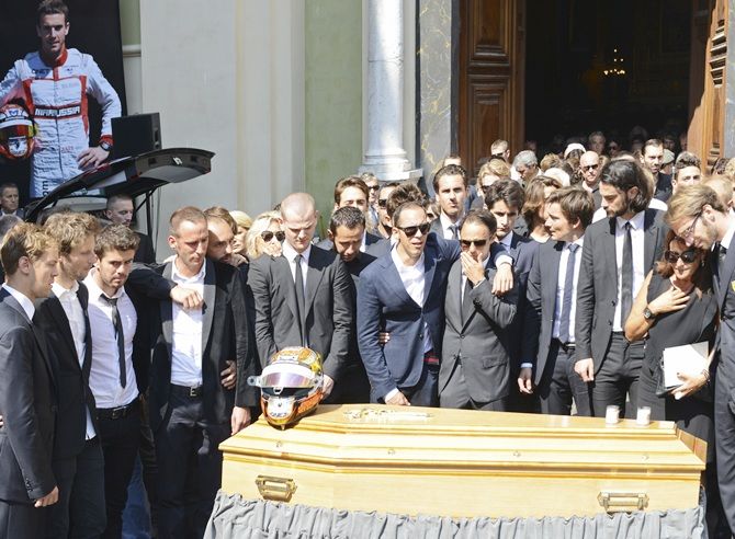 Friends and Formula One drivers gather around the coffin of late Marussia driver Jules Bianchi during the funeral in Nice