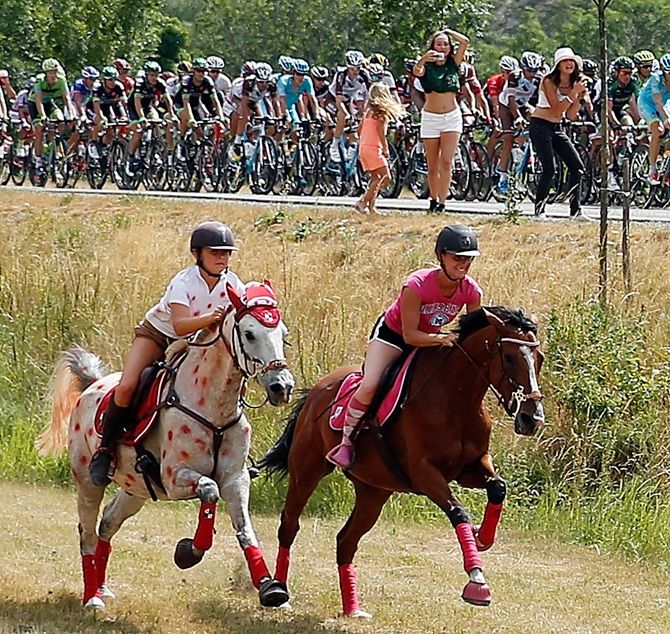  Horseback riders pace the peloton