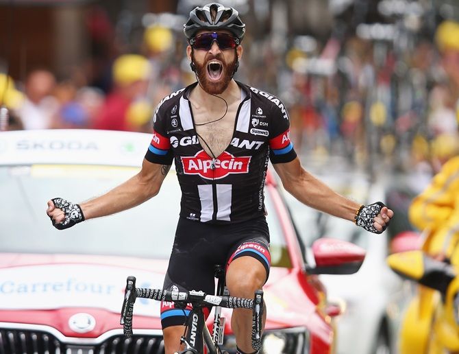 Simon Geschke of Germany and Team Giant-Alpecin crosses the finish line to win Stage 17 