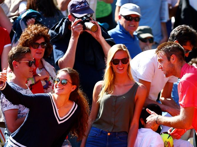 Jack Sock of the United States poses for photographs with fans