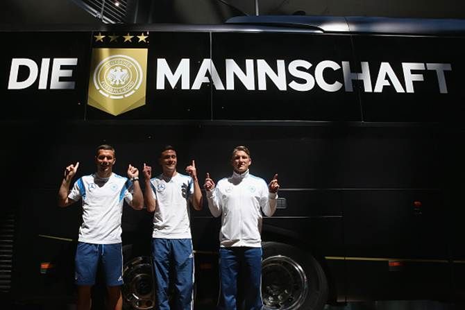 Germany’s Lukas Podolski, Jonas Hector and Bastian Schweinsteiger present the new team bus from Mercedes