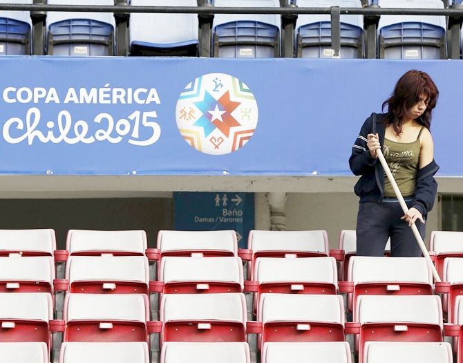 A woman cleans the stands at Chile's National Stadium