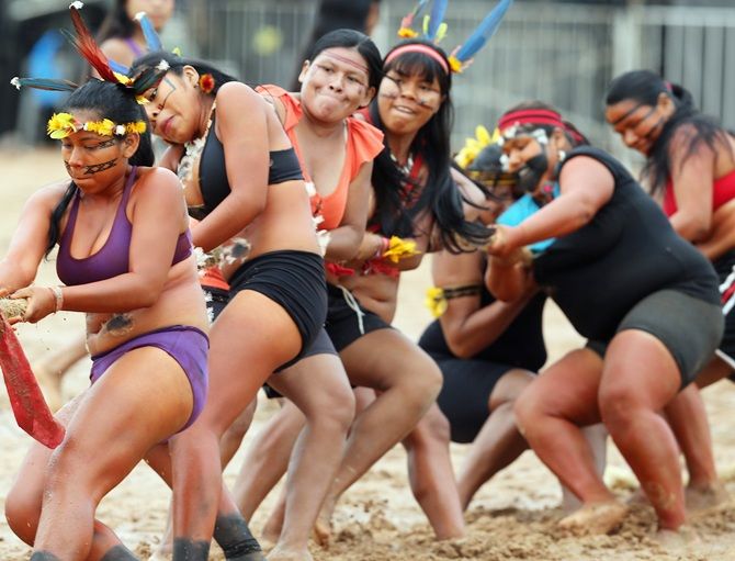 Members of the Brazilian Bororo indigenous ethnic group compete in a tug-of-war 