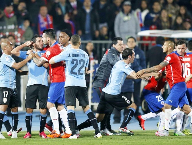  Chile (in red) and Uruguay players