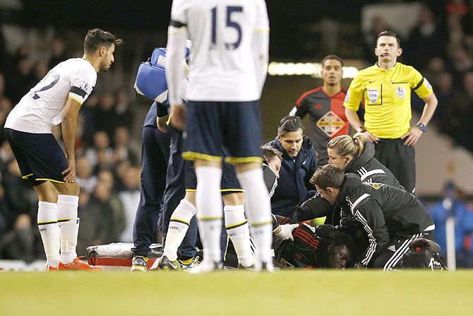 Swansea's Bafetimbi Gomis receives medical attention after sustaining an injury during the EPL match against Tottenham Hotspur on Wednesday
