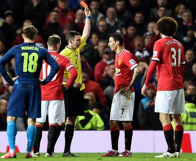 Referee Michael Oliver shows the red card to Angel di Maria of Manchester United