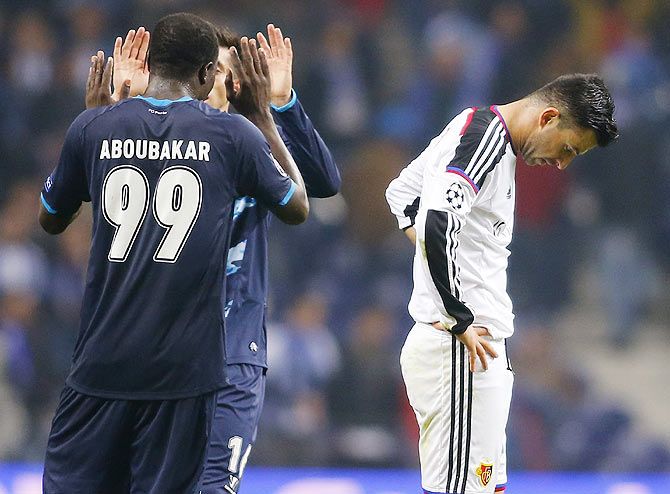FC Basel's Behrang Safari (right) reacts at the end their Champions League round of 16 second leg match against Porto at Dragao stadium in Porto on Tuesday