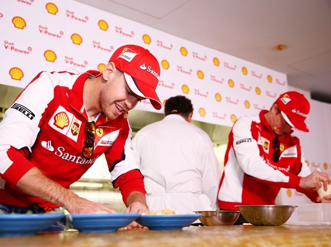 Sebastian Vettel of Germany and Ferrari and Kimi Raikkonen