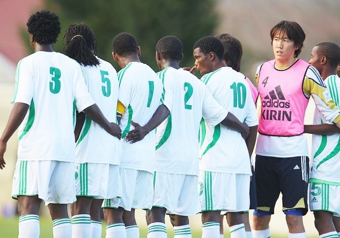 Kisho Yano of Japan watches on as he joins the Zimbabwe defensive wall