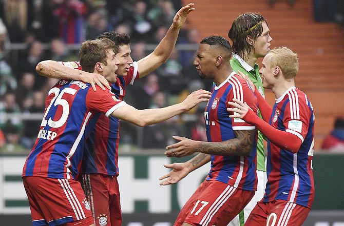 Bayern Munich's Robert Lewandowski (2nd from left) celebrates with teammates after netting a header during their German Bundesliga match against Werder Bremen in Bremen on Saturday