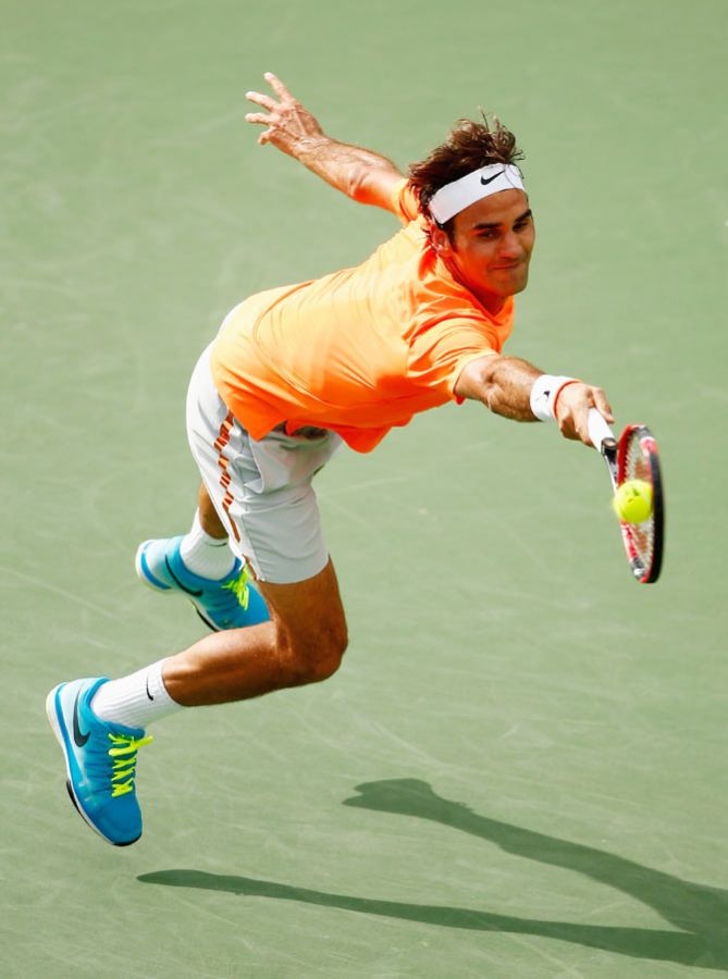 Roger Federer of Switzerland in action against Novak Djokovic of Serbia