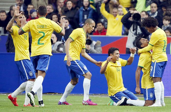 Brazil's Luiz Gustavo (2nd from right) celebrates with teammates after scoring against France during their international friendly match at the Stade de France, in Saint-Denis, near Paris, on Thursday